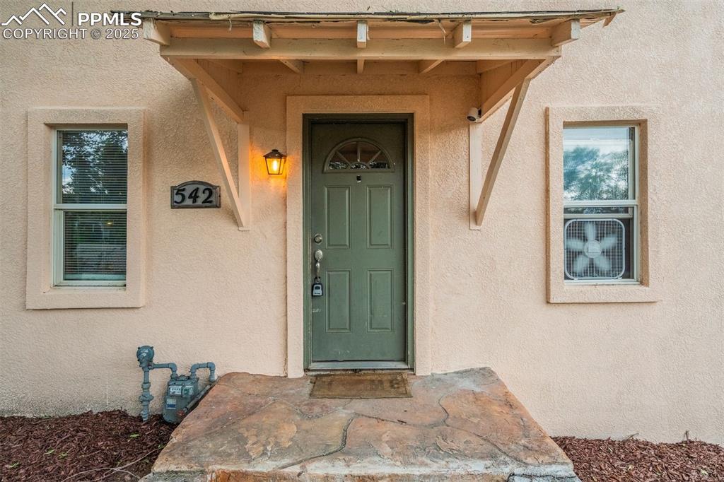 Image 3 of 24: View of exterior entry featuring stucco siding