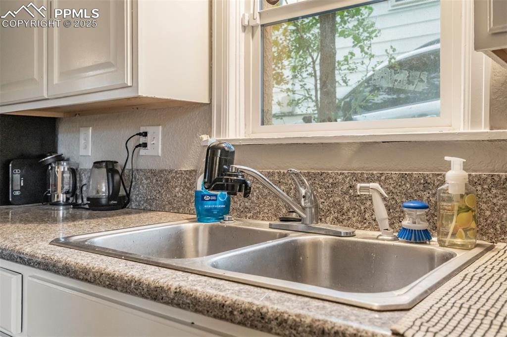 Image 9 of 24: Kitchen view of tasteful backsplash and light countertops