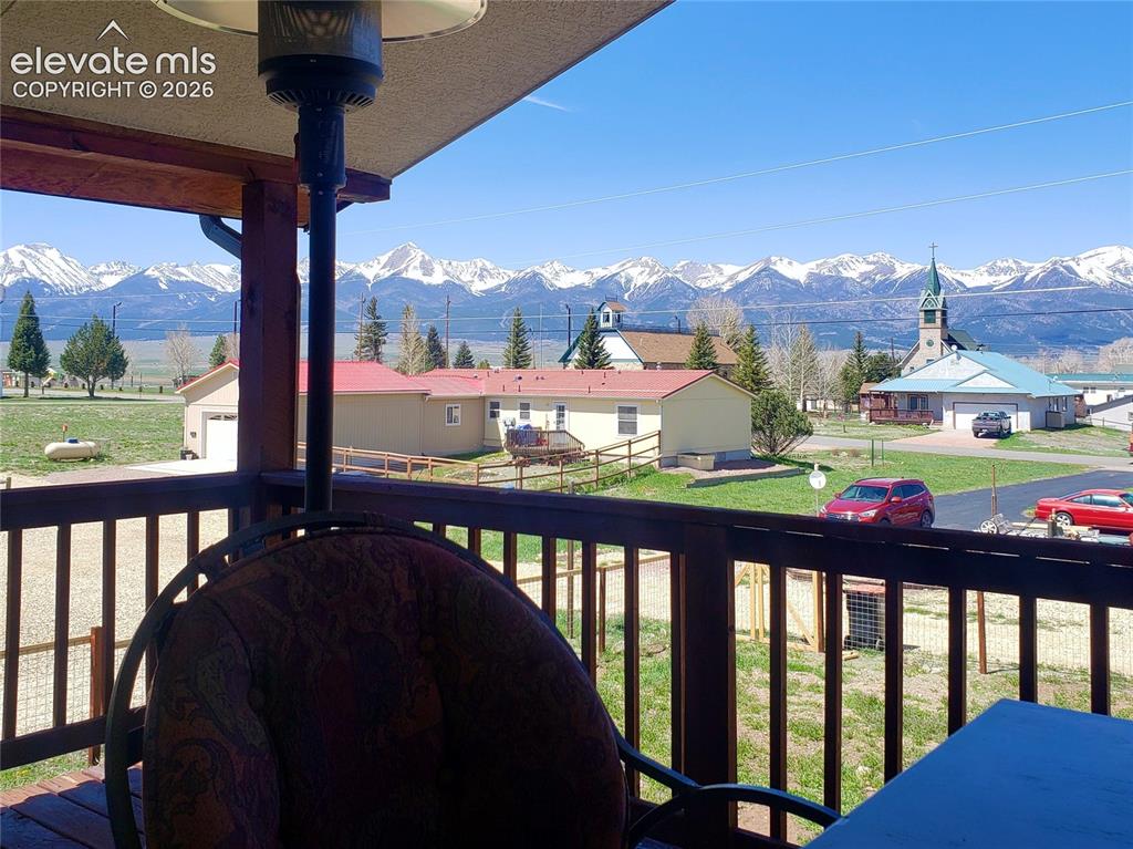 Image 12 of 12: Elevated wood deck with a partial railing and mountain scenery