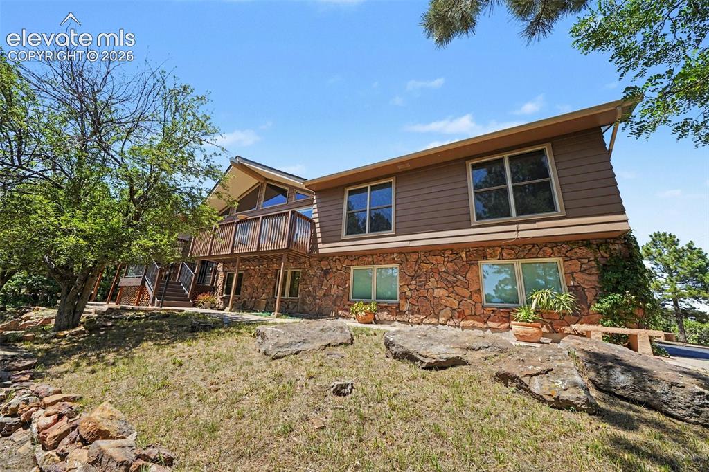 Image 31 of 42: Multi-level exterior featuring a stone facade and upper-level siding