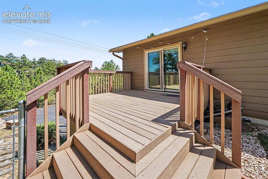 Image 39 of 42: Expansive exterior deck featuring a multi-level design, sturdy railing, and