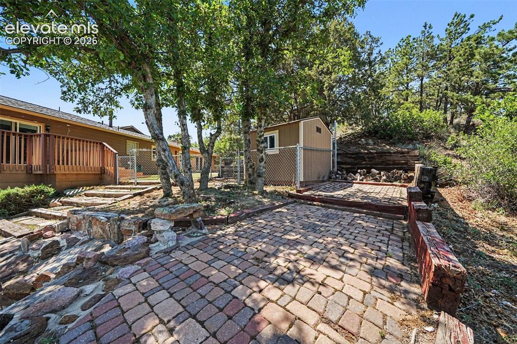 Image 40 of 42: Paver patio with in back yard
