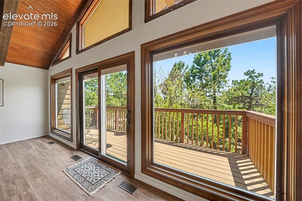 Image 7 of 42: Vaulted wood-paneled ceiling with exposed beam