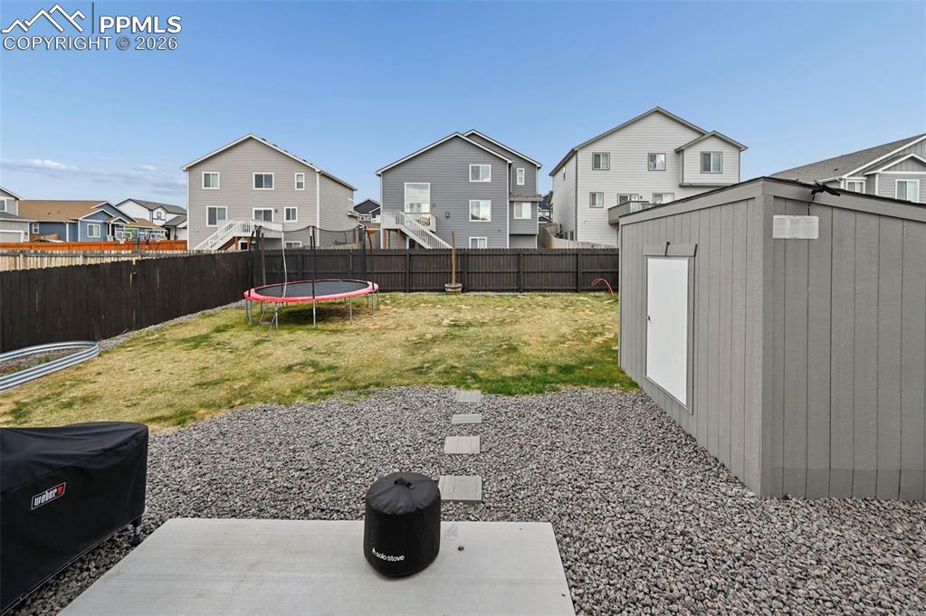 Image 28 of 38: with trampoline and large shed