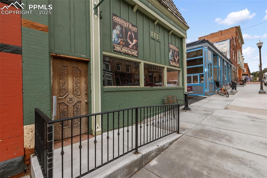 Image 2 of 34: Street-facing exterior with wide display windows and Victor’s historic main