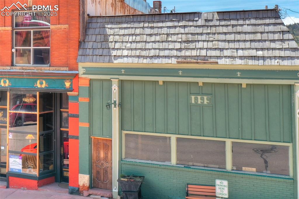 Image 31 of 34: 1899 storefront on Victor Avenue with tall display windows and classic hist