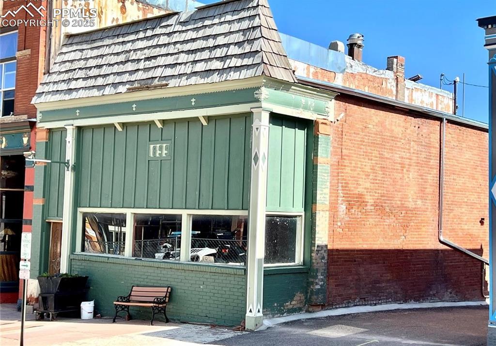 Image 7 of 34: Street-facing exterior with wide display windows and Victor’s historic main