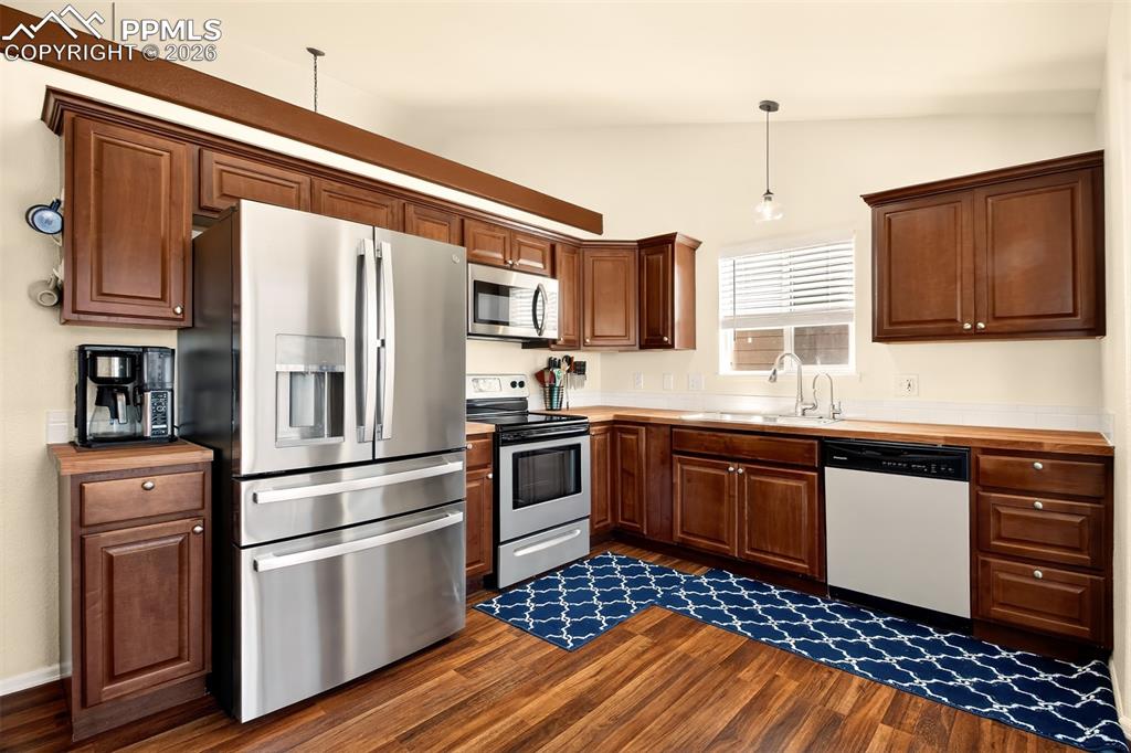 Image 10 of 36: Kitchen with stainless sleet appliances, plenty of cabinet space, butcher b