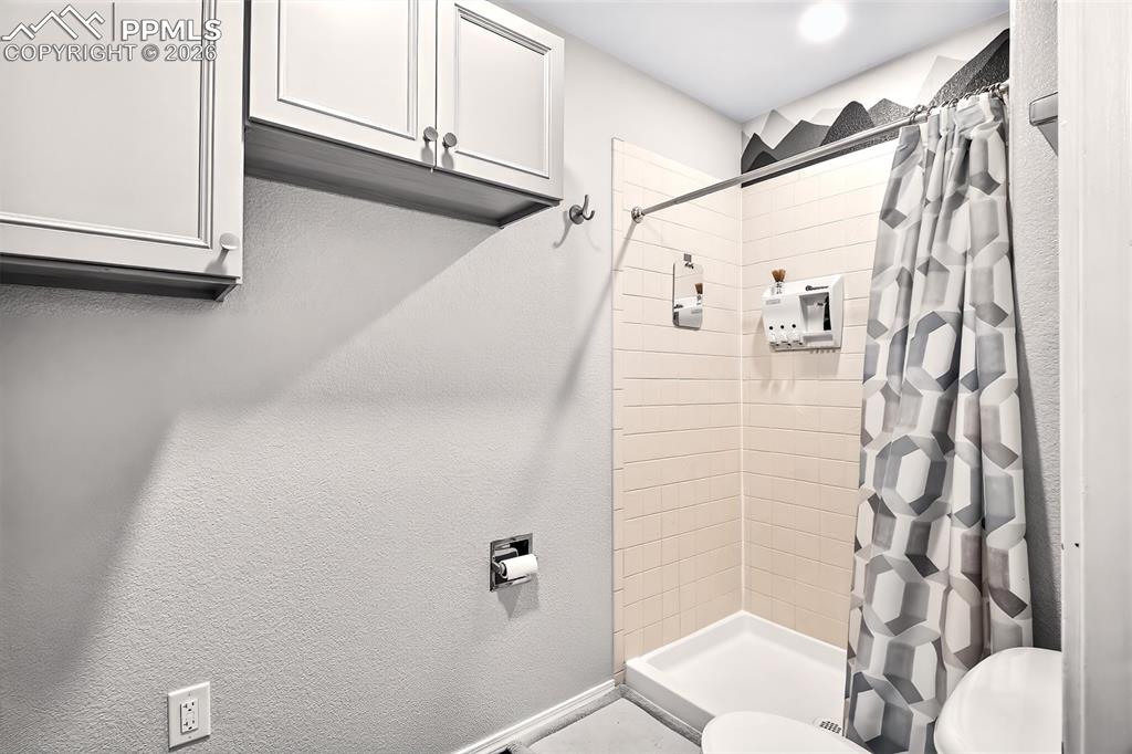 Image 18 of 36: Stand in shower in the 5 piece primary bathroom