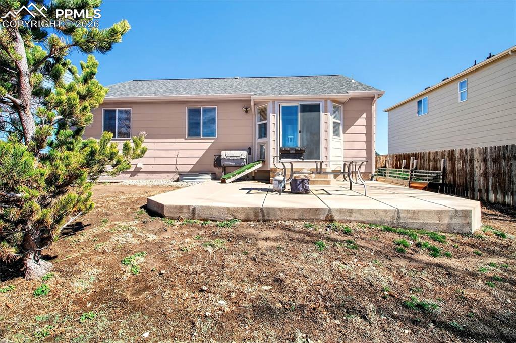 Image 27 of 36: Back patio and backyard