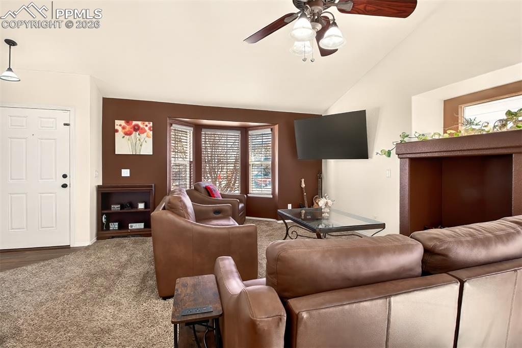 Image 5 of 36: Living room with gas fireplace and plenty of natural light 