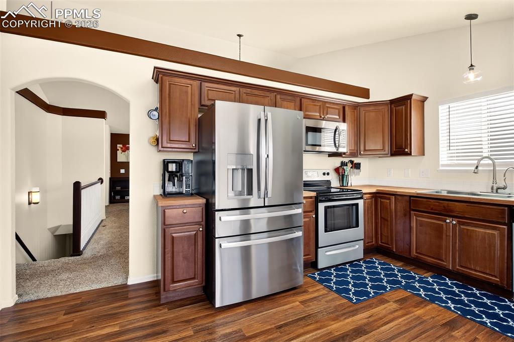 Image 8 of 36: Kitchen with stainless sleet appliances, plenty of cabinet space, butcher b