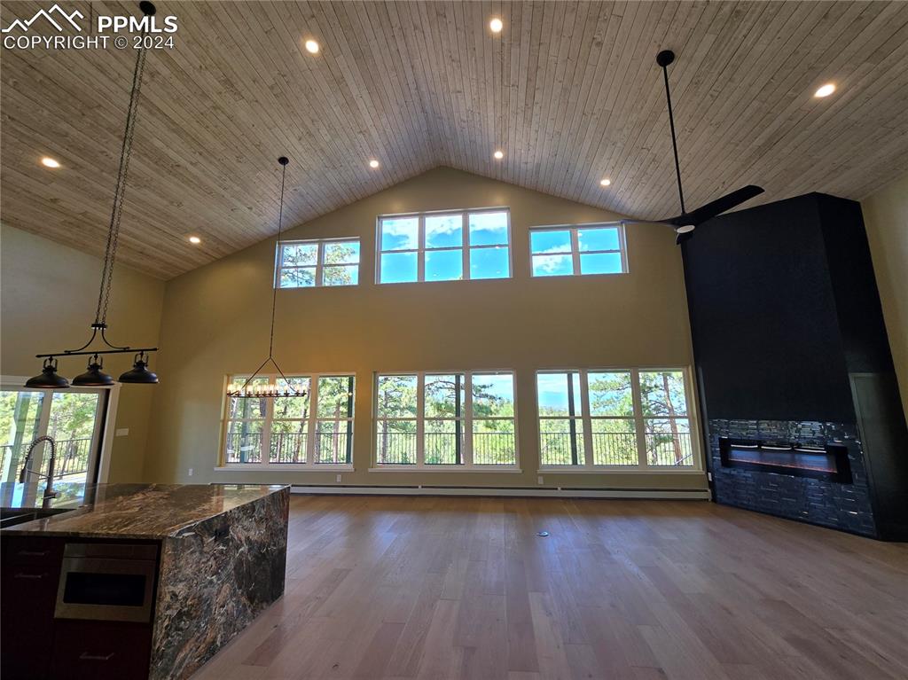 Image 14 of 50: Lving room with plenty of natural light, big mountain views, wood-type floo