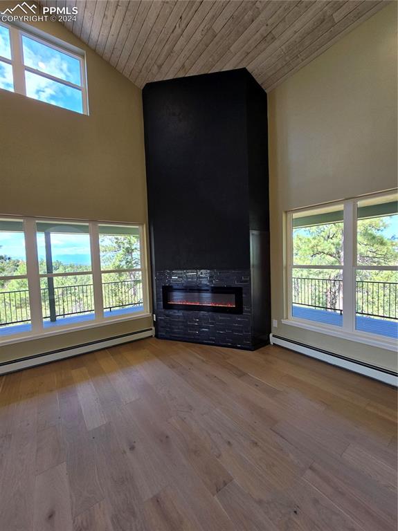 Image 15 of 50: Unfurnished living room with wooden ceiling, a healthy amount of sunlight,