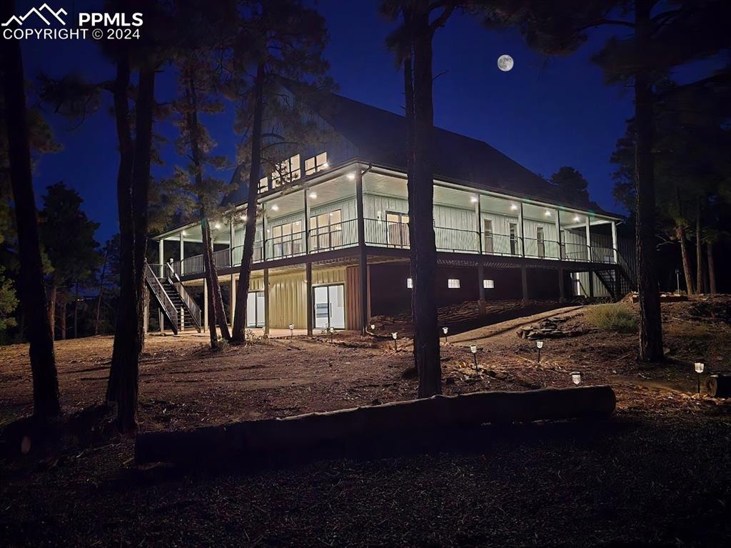 Image 2 of 50: View of back house at twilight