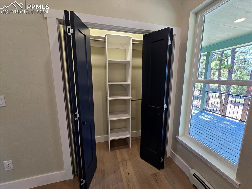 Image 31 of 50: Closet with a baseboard heating unit