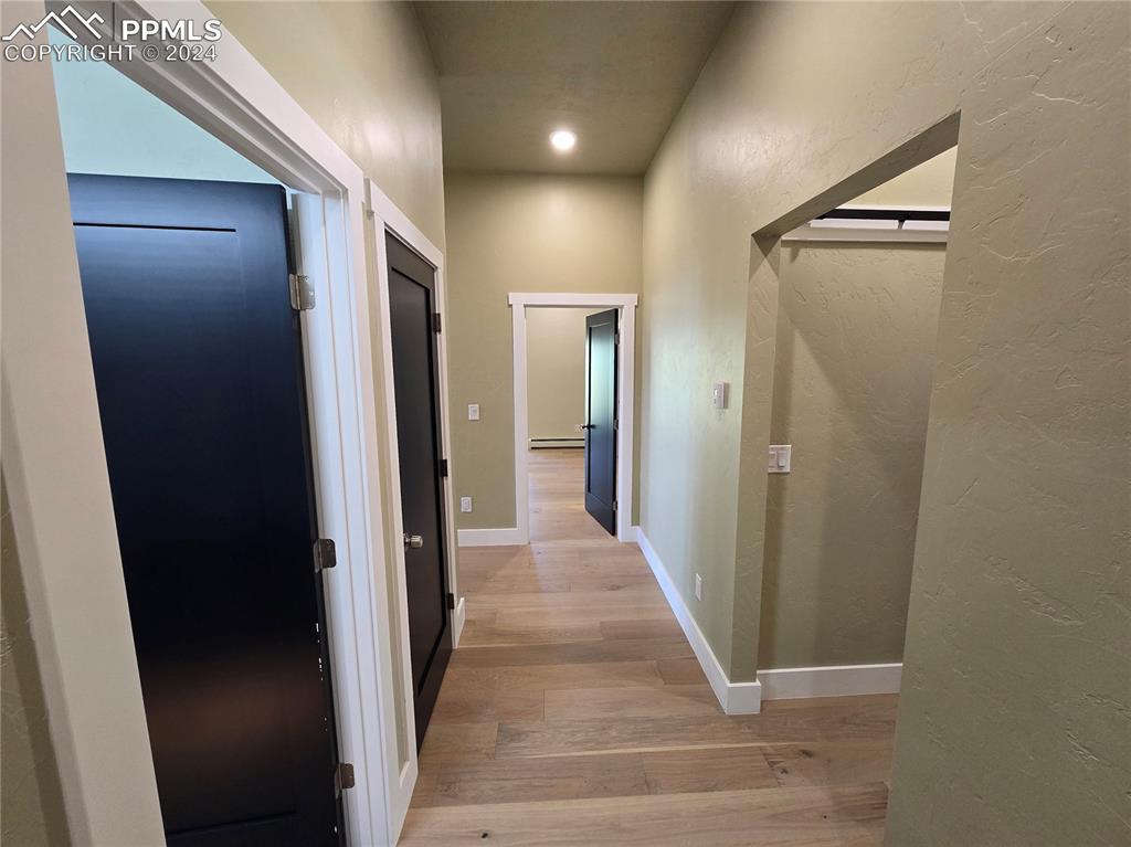Image 32 of 50: Corridor with light hardwood / wood-style flooring and a baseboard radiator