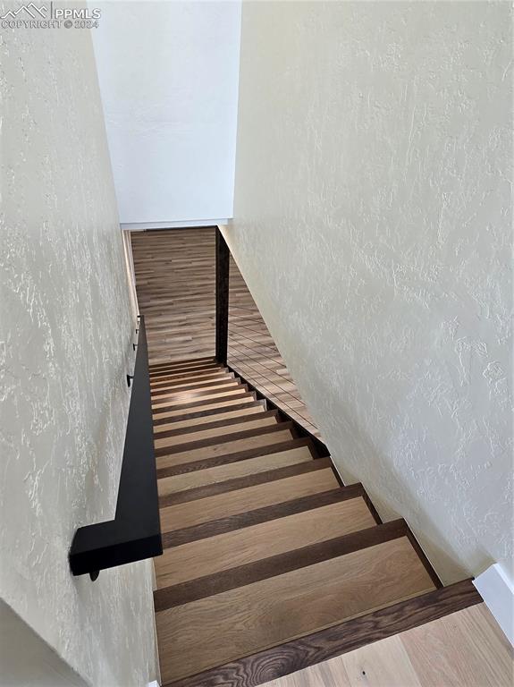 Image 38 of 50: Stairs with hardwood / wood-style flooring