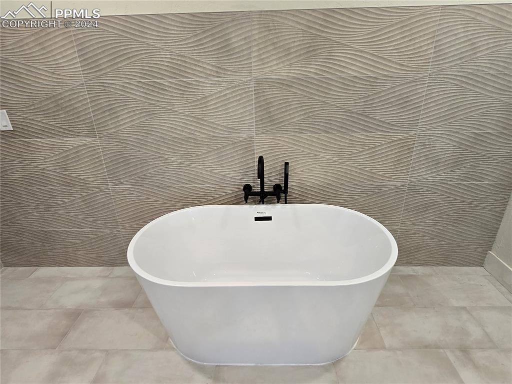 Image 42 of 50: Details featuring a bathing tub and tile patterned floors