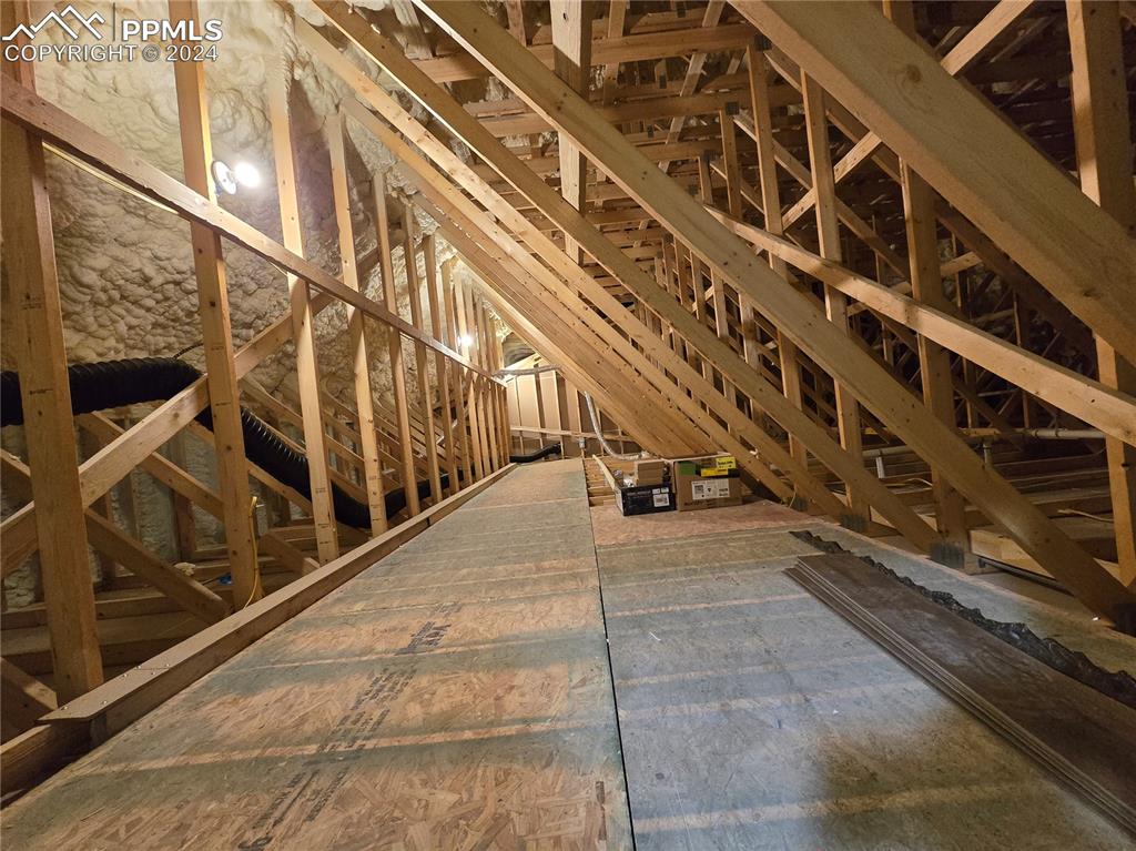 Image 48 of 50: View of attic with plendy of storage space. This attic is accessable from t