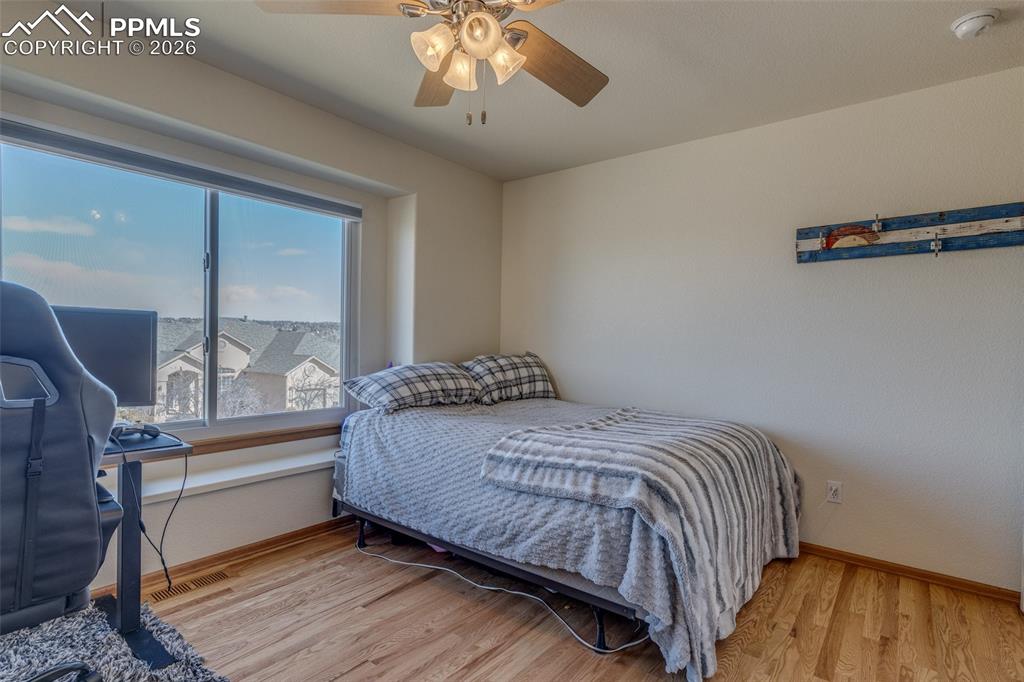 Image 34 of 48: Bedroom featuring light wood-style flooring and a ceiling fan