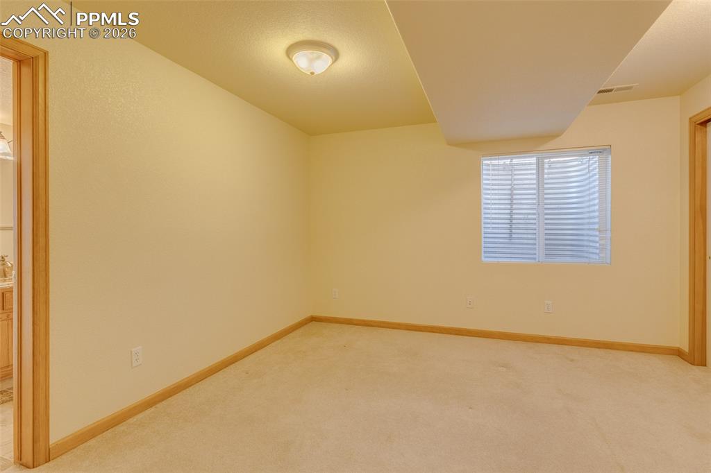 Image 39 of 48: Empty room with light carpet and baseboards