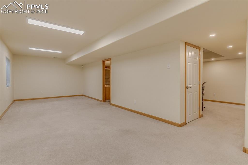 Image 46 of 48: Finished below grade area with light carpet and recessed lighting