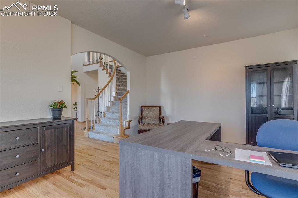 Image 8 of 48: Office area featuring light wood-type flooring and arched walkways