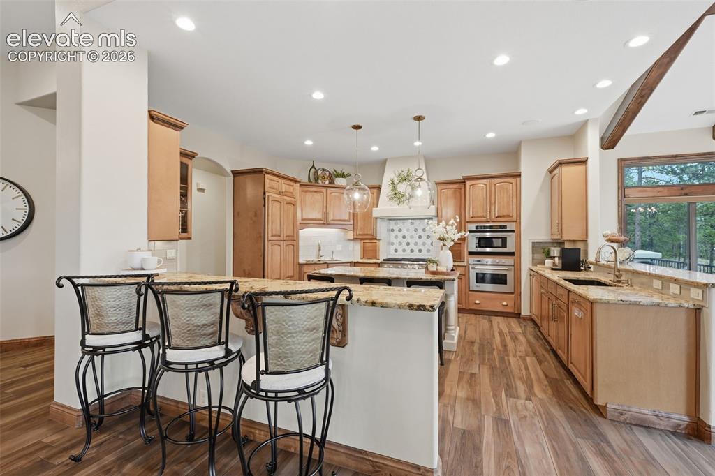 Image 11 of 50: Updated kitchen with Bosch appliances and custom refrigerator.
