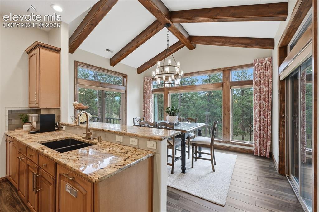 Image 12 of 50: Eat in kitchen with beams and windows on three sides!