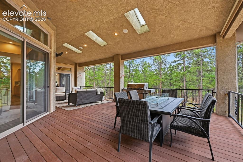 Image 16 of 50: Covered deck with heaters, gas line and blinds!