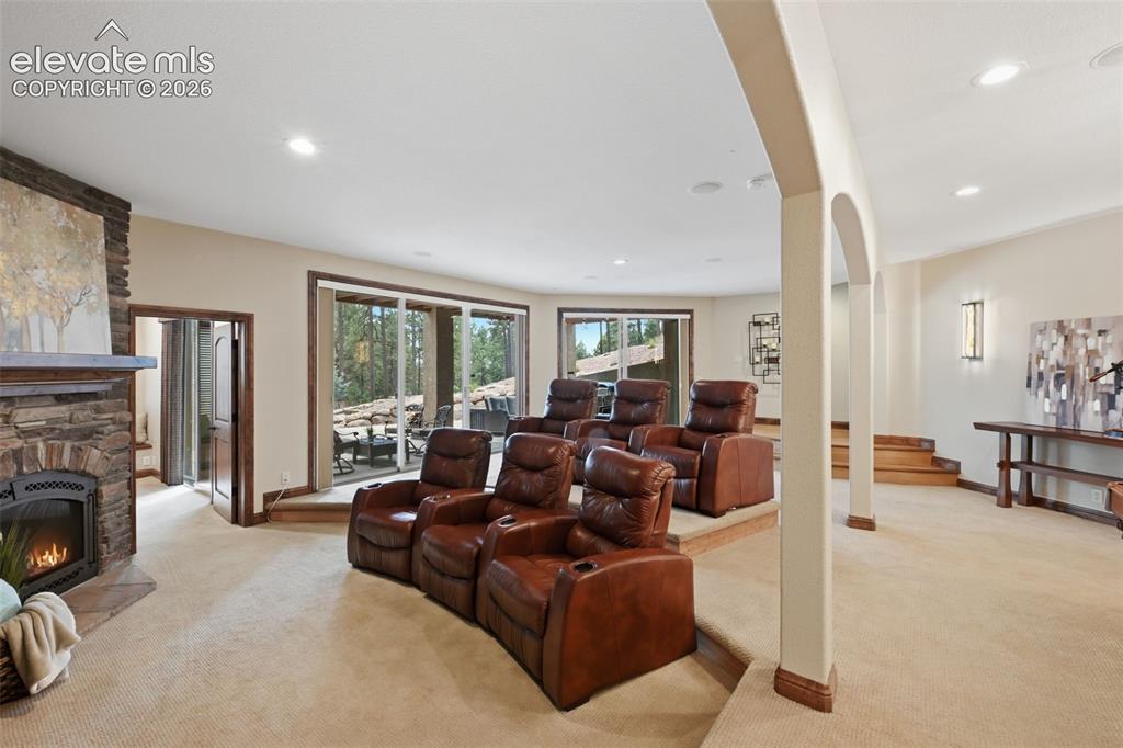 Image 28 of 50: Walkout basement with media room and third fireplace!