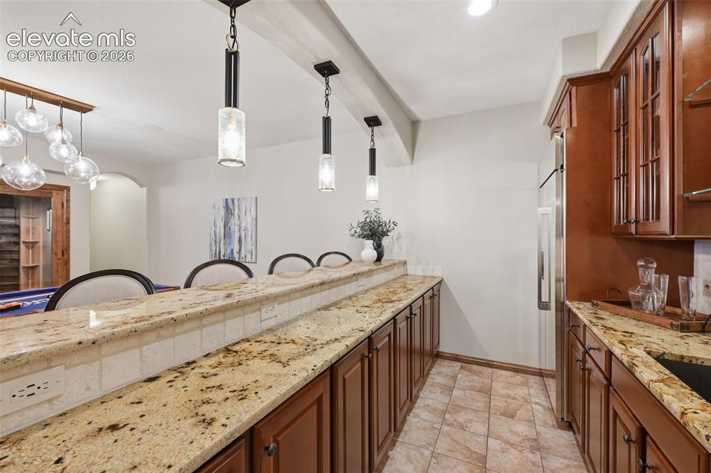 Image 31 of 50: Wet bar with full cabinets and refrigerator!
