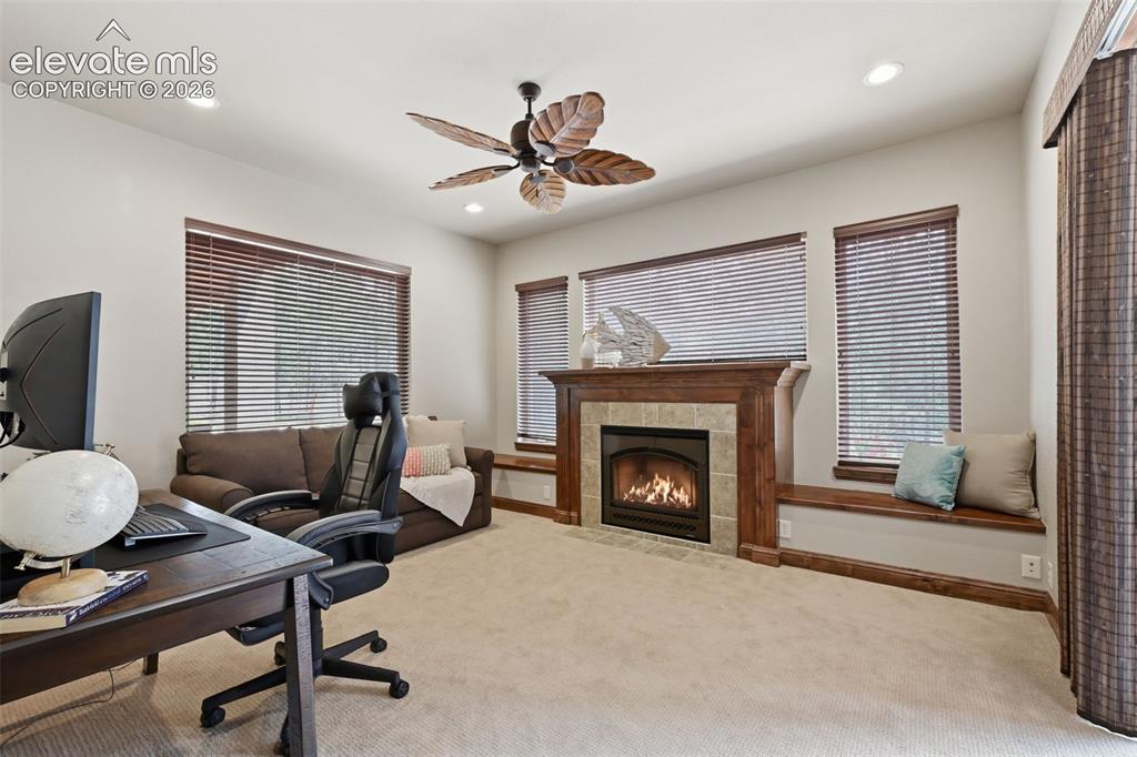 Image 34 of 50: Second office in the basement with walkout to patio and fourth fireplace!