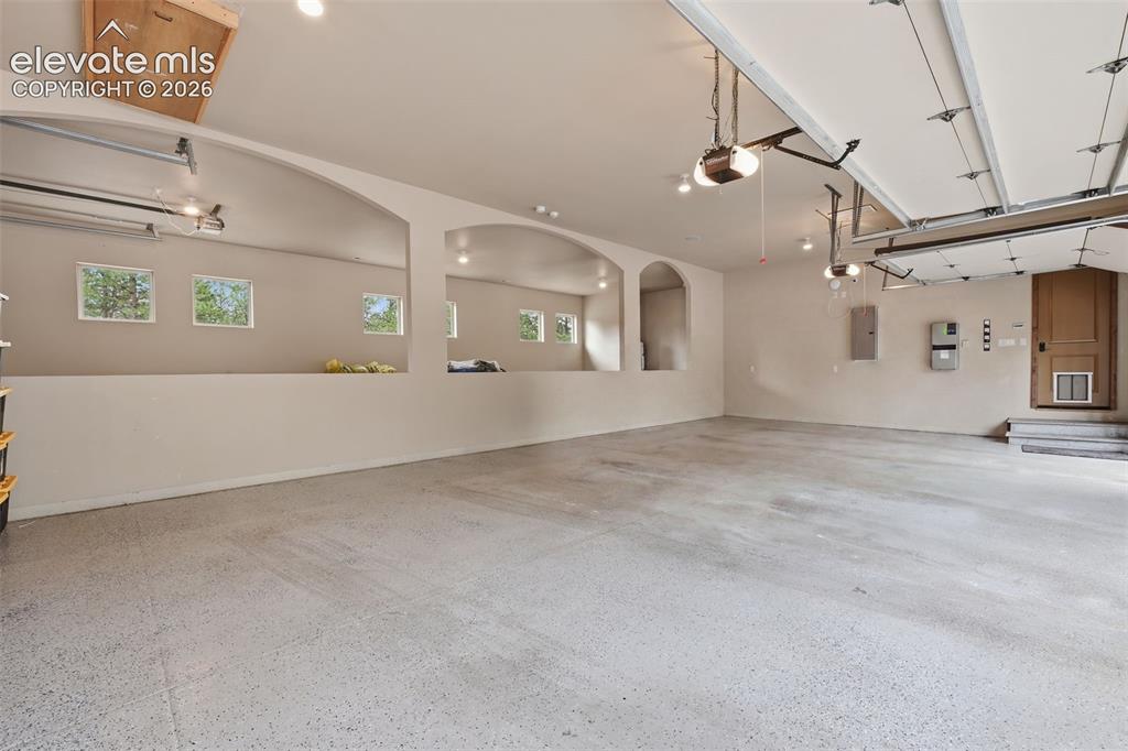 Image 44 of 50: Amazing 4 car attached garage with step down attached RV garage!