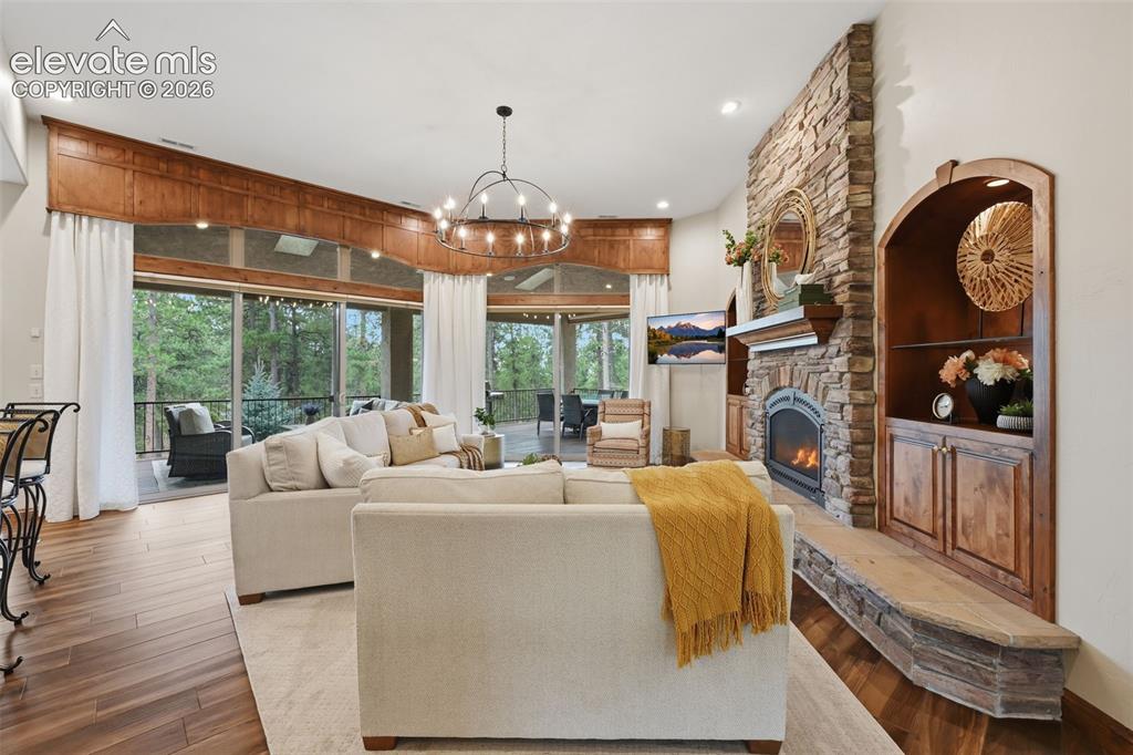 Image 8 of 50: Stunning family room with wall of windows to the covered decks!