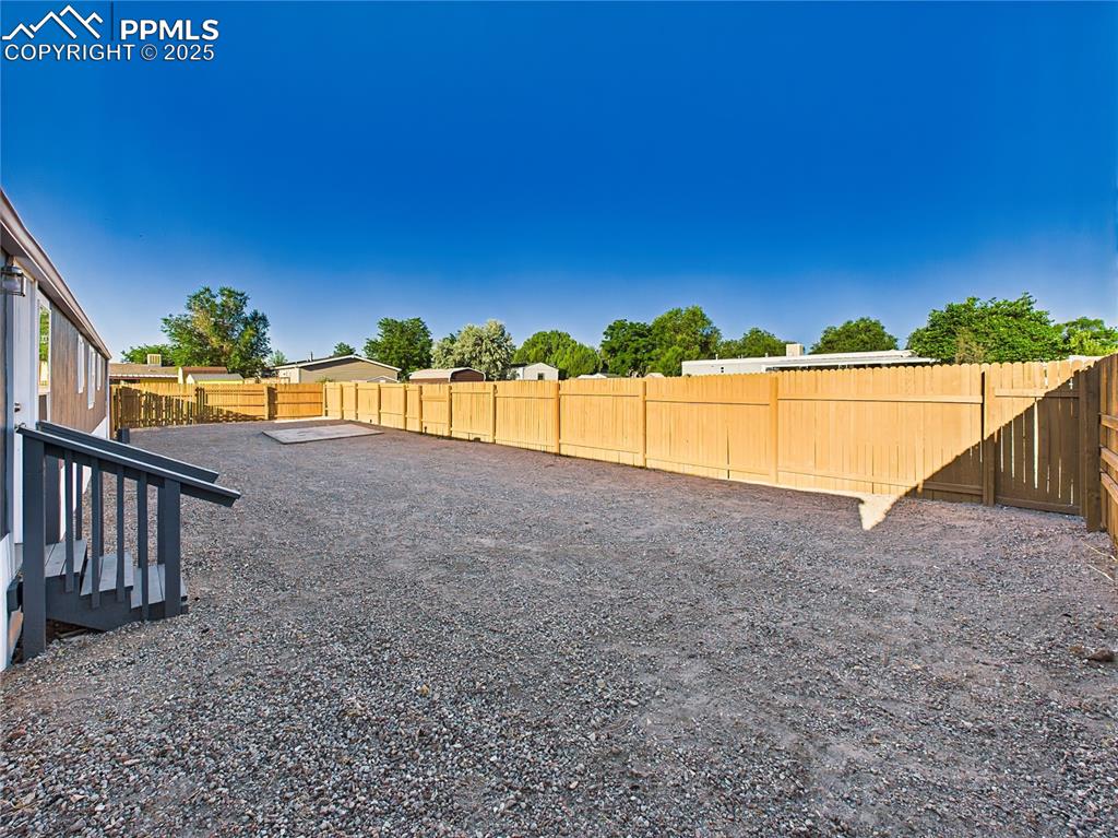Image 41 of 43: Backyard – Open View – Expansive fenced-in area offers flexibility for gard