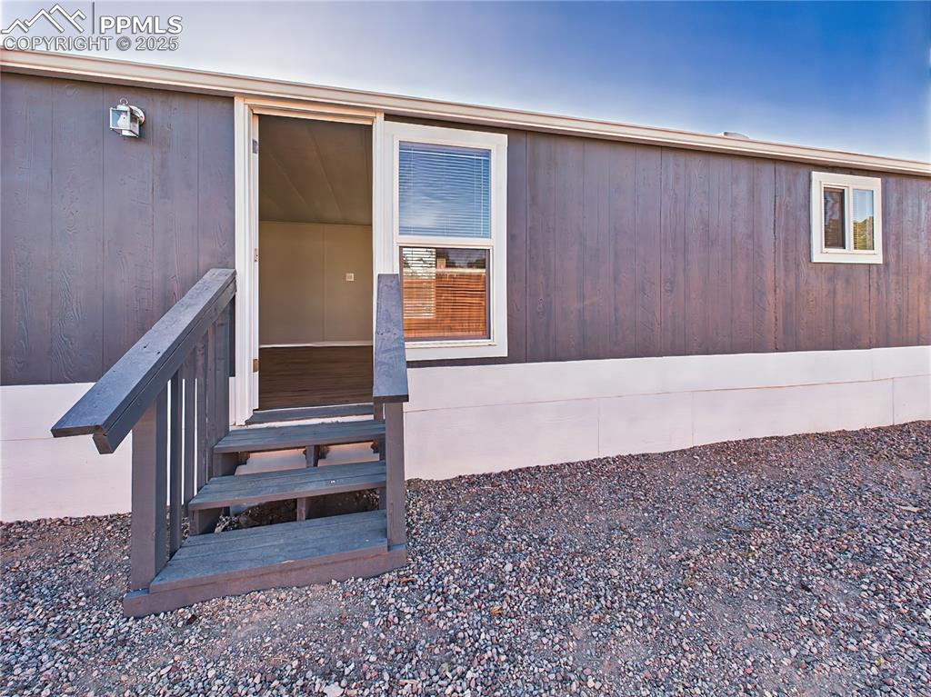 Image 42 of 43: Rear Entry – Exterior View – Rear exterior features a private entrance with