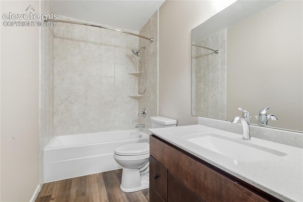Image 25 of 35: Full-size mirror, single vanity with integrated sink, chrome faucet, bathtu