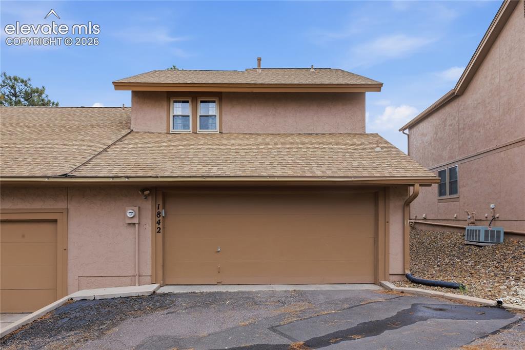 Image 35 of 35: Stucco exterior with an attached garage