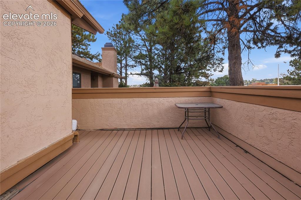 Image 7 of 35: Expansive patio featuring composite decking, stucco exterior walls, and a p