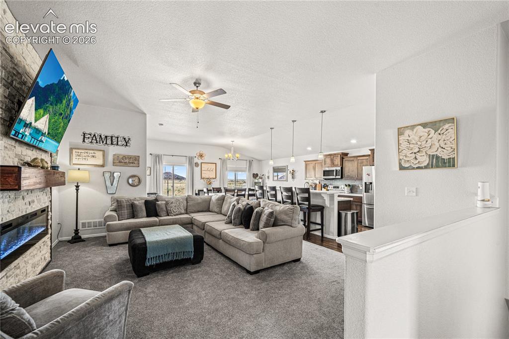 Image 13 of 50: Expansive living area featuring vaulted ceilings and recessed lighting