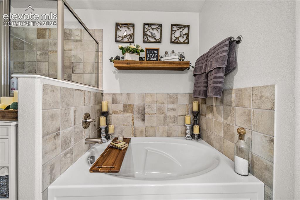 Image 19 of 50: Built-in soaking tub with brushed nickel fixtures
