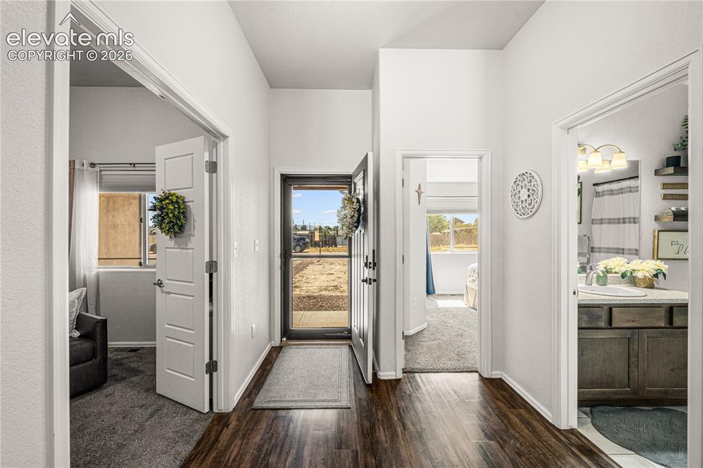 Image 3 of 50: Entryway featuring wood-finish flooring, a full-lite door with a storm door