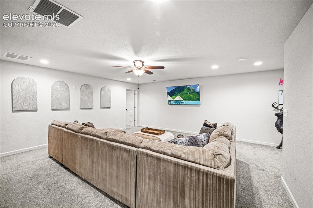 Image 37 of 50: Spacious room with recessed lighting, a ceiling fan, and light gray carpeti