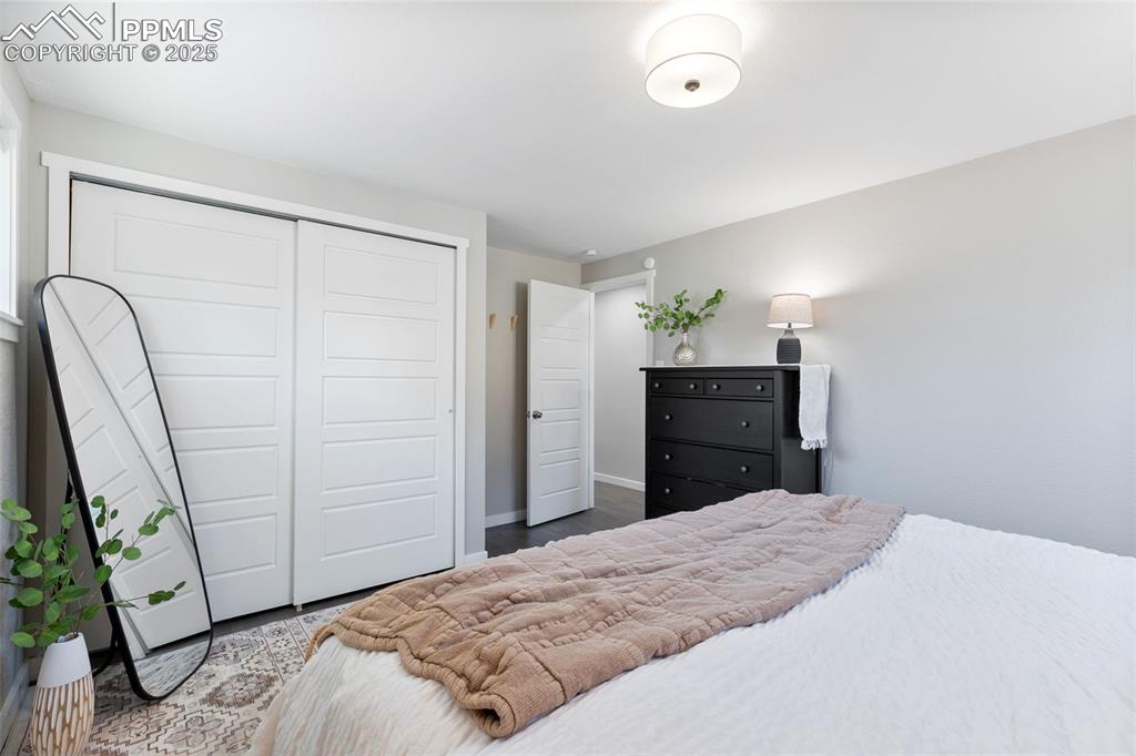 Image 12 of 37: Bedroom featuring a closet and wood finished floors