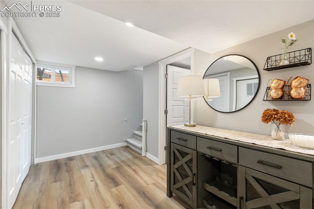 Image 19 of 37: Bathroom with light wood finished floors, vanity, and recessed lighting