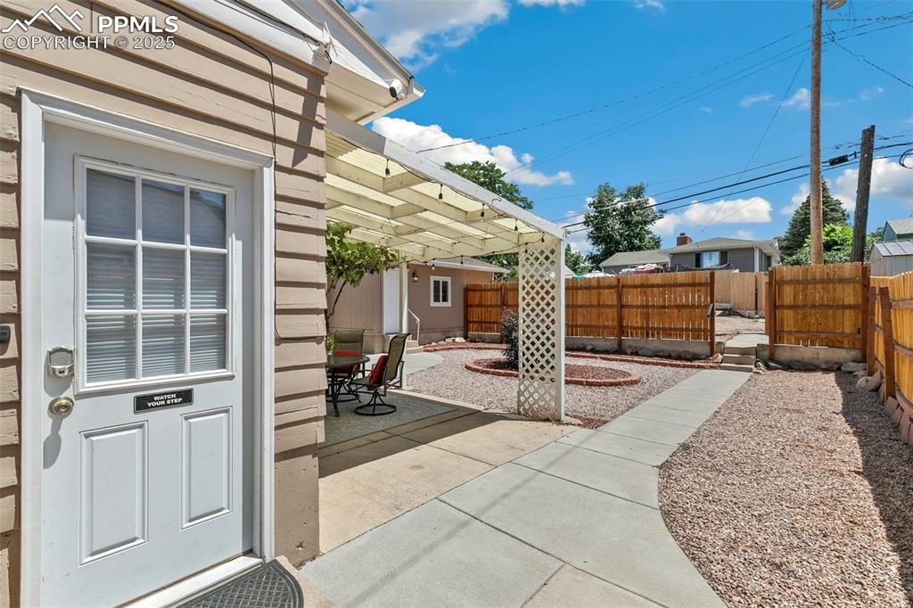 Image 32 of 37: Fenced backyard featuring a patio area