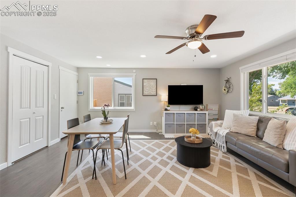 Image 8 of 37: Living room with wood finished floors, recessed lighting, and ceiling fan