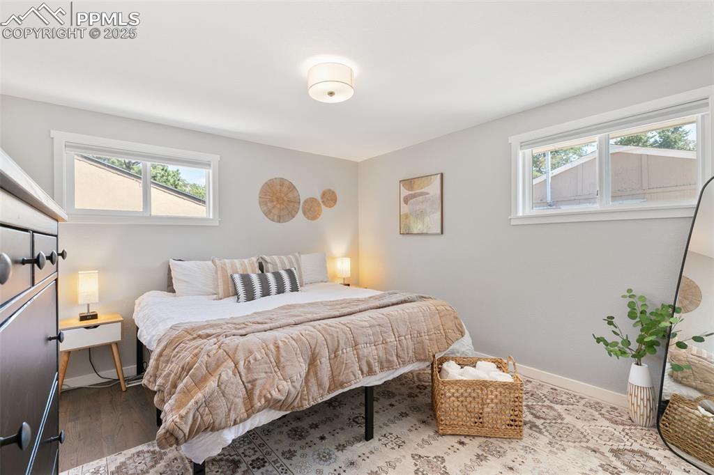 Image 9 of 37: Bedroom with baseboards and wood finished floors